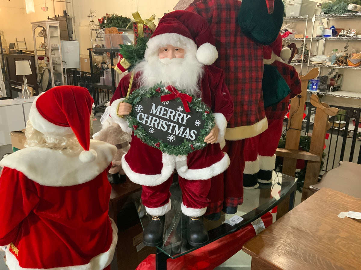 Santa with Merry Christmas Sign